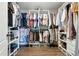 This expansive walk-in closet has custom shelving and ample hanging space for organization at 16262 Firedragon Dr, Winter Garden, FL 34787