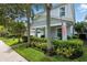 Charming two-story home featuring a cozy front porch, manicured lawn, and vibrant landscaping at 16262 Firedragon Dr, Winter Garden, FL 34787
