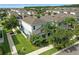 Charming two-story home featuring a well-manicured lawn, palm trees, and a white picket fence at 16262 Firedragon Dr, Winter Garden, FL 34787