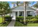 Charming home featuring a well-manicured lawn, lush landscaping, and welcoming covered front porch at 16262 Firedragon Dr, Winter Garden, FL 34787