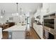 Bright kitchen with white cabinetry, quartz countertops, stainless appliances and stylish pendant lighting at 16262 Firedragon Dr, Winter Garden, FL 34787