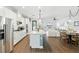 Open-concept kitchen with island, stainless steel appliances, and hardwood floors at 16262 Firedragon Dr, Winter Garden, FL 34787