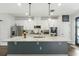 Modern kitchen with large island, white cabinets, and stainless steel appliances at 16262 Firedragon Dr, Winter Garden, FL 34787