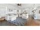 Cozy living room with white sofa, chairs, and a patterned blue rug at 16262 Firedragon Dr, Winter Garden, FL 34787
