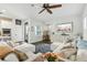 Bright open living room features a ceiling fan and hardwood floors at 16262 Firedragon Dr, Winter Garden, FL 34787