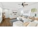 Bright living room with stylish furnishings, plush seating, and a decorative rug over hardwood floors at 16262 Firedragon Dr, Winter Garden, FL 34787