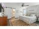Primary bedroom with ceiling fan and hardwood floors, with open bathroom entrance at 16262 Firedragon Dr, Winter Garden, FL 34787