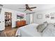 Primary bedroom with hardwood floors, ceiling fan, and sliding closet door at 16262 Firedragon Dr, Winter Garden, FL 34787