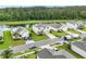 Lovely aerial view of a home with verdant lawns, a serene pond, and picturesque neighborhood at 16436 Fernridge St, Clermont, FL 34714