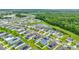 Aerial view of home with lush green landscape, large pond, and community at 16436 Fernridge St, Clermont, FL 34714