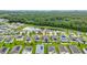 An aerial view shows a well-maintained neighborhood with a pond and green spaces at 16436 Fernridge St, Clermont, FL 34714
