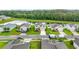 Scenic aerial view of a home with verdant lawns, serene pond, and picturesque neighborhood at 16436 Fernridge St, Clermont, FL 34714