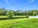 Expansive backyard with lush greenery and serene pond views for outdoor enjoyment at 16436 Fernridge St, Clermont, FL 34714