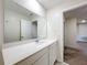 Clean bathroom features a white quartz countertop, large mirror and neutral wall color at 16436 Fernridge St, Clermont, FL 34714