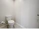 Compact half bathroom featuring a standard toilet and neutral wall and flooring at 16436 Fernridge St, Clermont, FL 34714