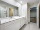 Stylish Primary bathroom featuring a double-sink vanity, a large mirror, and tile floors at 16436 Fernridge St, Clermont, FL 34714