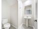 Bright half bathroom featuring a pedestal sink, tile floors and modern fixtures at 16436 Fernridge St, Clermont, FL 34714