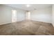 Spacious bedroom with plush carpeting, and an open doorway to the connected bathroom at 16436 Fernridge St, Clermont, FL 34714