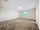 Neutral bedroom with carpet and a window offers a peaceful personal space to recharge and relax at 16436 Fernridge St, Clermont, FL 34714