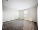 Bright bedroom with a window, plush carpeting, and neutral walls at 16436 Fernridge St, Clermont, FL 34714