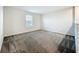 Neutral bedroom with a window allowing natural light to illuminate the carpeted floor at 16436 Fernridge St, Clermont, FL 34714