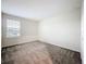Cozy bedroom with neutral walls, carpet, and a window, offering a relaxing retreat at 16436 Fernridge St, Clermont, FL 34714