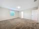 Spacious bedroom featuring neutral walls, plush carpeting, and a window for natural light at 16436 Fernridge St, Clermont, FL 34714