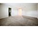 Spacious carpeted bedroom with neutral walls and adjacent bath promotes relaxation and comfort at 16436 Fernridge St, Clermont, FL 34714
