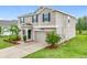 Beautiful two-story home with a two car garage, lovely landscaping and a well manicured lawn at 16436 Fernridge St, Clermont, FL 34714