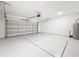 Spacious two car garage with epoxy floors, automatic door and high ceilings at 16436 Fernridge St, Clermont, FL 34714