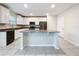 Spacious kitchen with white cabinetry, stainless steel appliances, and large island at 16436 Fernridge St, Clermont, FL 34714