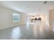 Open-concept living room with neutral paint, tile floors, and a combined kitchen for easy entertaining at 16436 Fernridge St, Clermont, FL 34714