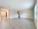 Inviting living room with tile flooring, a staircase, and large windows for natural light at 16436 Fernridge St, Clermont, FL 34714