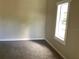 Bedroom featuring carpeted flooring and a well lit window at 200 W Doane Ave, Eustis, FL 32726