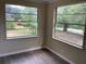 This bedroom features dark flooring and two large windows providing plenty of natural light at 200 W Doane Ave, Eustis, FL 32726