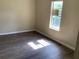 Bedroom featuring hard wood floors, base trim, and a well lit window at 200 W Doane Ave, Eustis, FL 32726