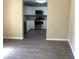 View into the kitchen featuring stainless steel appliances and white cabinets at 200 W Doane Ave, Eustis, FL 32726