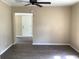 Open-concept living room featuring dark flooring and a ceiling fan at 200 W Doane Ave, Eustis, FL 32726