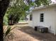 Home exterior featuring an AC unit and lamp with landscaping, showing the side of the home at 200 W Doane Ave, Eustis, FL 32726
