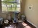 Small utility room filled with buckets and storage items featuring laminate flooring and natural light at 200 W Doane Ave, Eustis, FL 32726