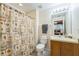 The bathroom features a themed shower curtain, toilet and sink at 214 Paloma Dr, Davenport, FL 33837