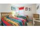Cheerful bedroom with twin beds, featuring colorful striped quilts and cartoon character decorations at 214 Paloma Dr, Davenport, FL 33837