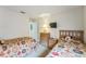 Inviting bedroom with twin beds, dressers, carpeted floor and TV mounted to the wall at 214 Paloma Dr, Davenport, FL 33837