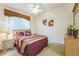 Comfortable bedroom with a large window, ceiling fan, and neutral decor at 214 Paloma Dr, Davenport, FL 33837