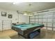 Spacious game room featuring a pool table, air hockey and garage door in background at 214 Paloma Dr, Davenport, FL 33837