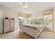 Spacious main bedroom with a large window, ceiling fan, and access to the backyard at 214 Paloma Dr, Davenport, FL 33837