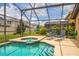 Inviting pool and hot tub area, with screened enclosure and patio furniture at 214 Paloma Dr, Davenport, FL 33837