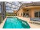 Inviting screened-in pool area with a relaxing spa and ample seating for outdoor enjoyment at 214 Paloma Dr, Davenport, FL 33837