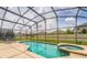 Relaxing pool with screened enclosure and lounge chairs, complete with attached hot tub for leisurely comfort at 214 Paloma Dr, Davenport, FL 33837