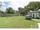 Spacious backyard with a large lawn, a privacy fence, and room for outdoor activities at 2430 Westwood Dr, Longwood, FL 32779